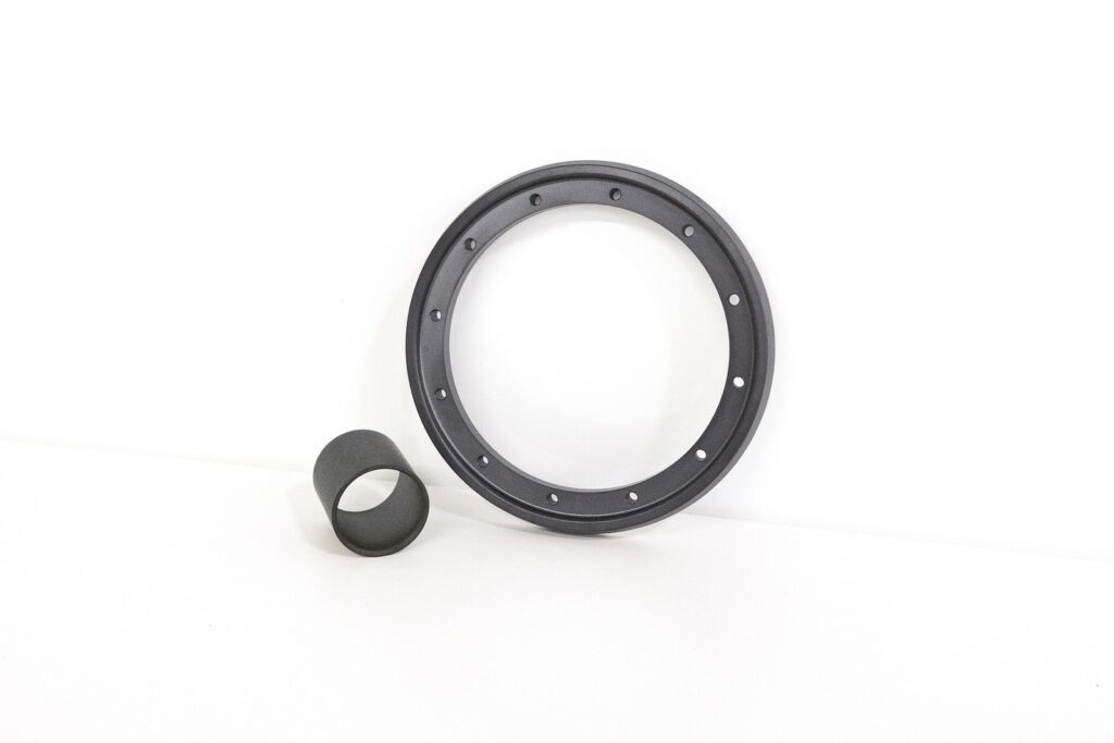 Bushing and mounting bracket machined from Torlon tube in a bearing and wear grade